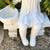 Beautiful girl with basket sitting on bench garden statue 3 thumbnail