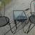 two metal chairs with end table with glass top 1 thumbnail