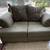 Green Loveseat Sofa with Patterned Cushins 1 thumbnail