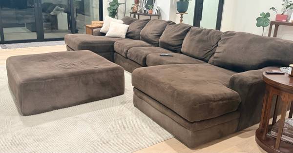Large comfortable brown sectional couch with matching ottoman 1