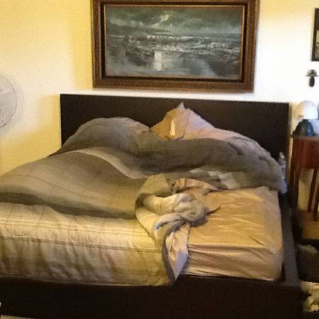 IKEA brand king sized bed frame and two drawers that slide underneath 1