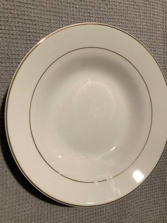 Cream trimmed in gold dinnerware. 1