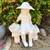 Beautiful girl with basket sitting on bench garden statue 1 thumbnail