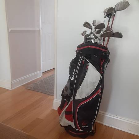 Golf bag with Ping clubs and Wilson drive. 1
