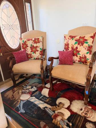 two elegant wooden armchairs with carved details and beige up 1