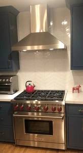 Wall range hood in a pyramid style features standard finish in SS 1