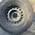One Toyota truck 16 inch stock steel 6 lug rim and old tire 1 thumbnail