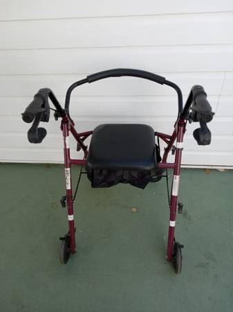 4-wheel  maroon Walker with seat and brakes for sale in Osprey.$55 1