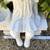 Beautiful girl with basket sitting on bench garden statue 5 thumbnail
