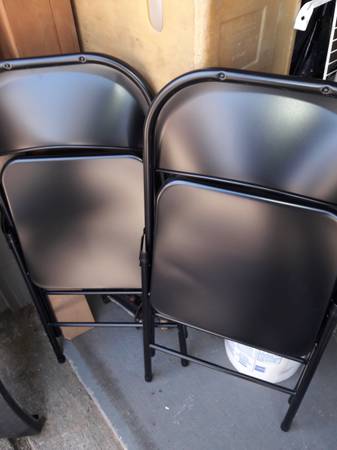 2 black metal folding chairs 1