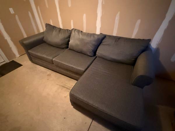 Grey sectional couch with pull out bed 1