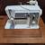 Singer sewing machine in cabinet with accessories 1 thumbnail