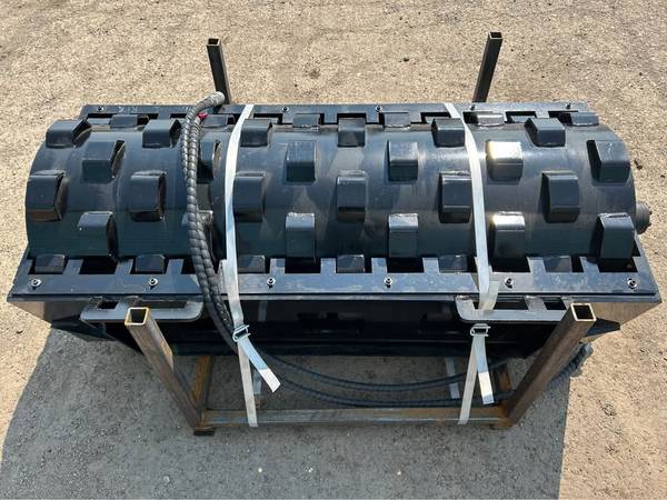 Skid steer padded vibratory roller compactor attachment 1