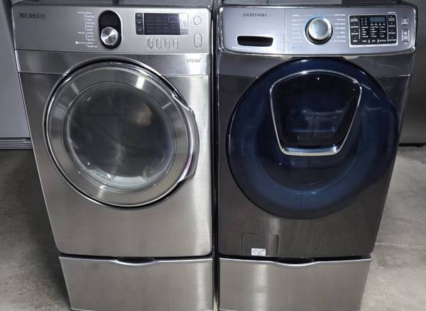 Samsung stainless front loading laundry pair on pedestals 1