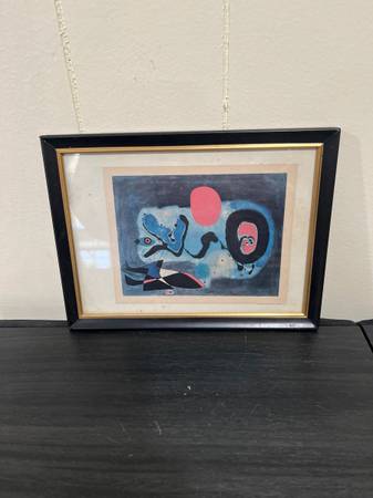 A framed print in the style of Joan  Miro “ the red sun” 1