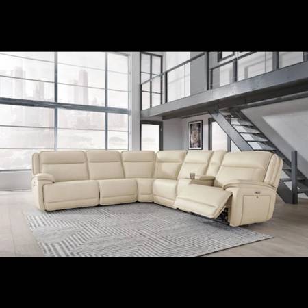 modern loft-style living space with a large cream-colored sectional reclining so 1