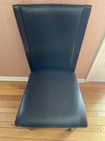 Chairs black with padded faux leather seats and backs 1