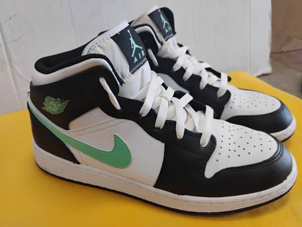 7Y Air Jordan 1 Mid sneakers featuring a distinct mint-green swoosh against a wh