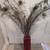 Peacock feathers in a tall red glass container 1 thumbnail