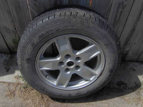 1  235-65R-17 Wrangler tire on a dodge rim 1