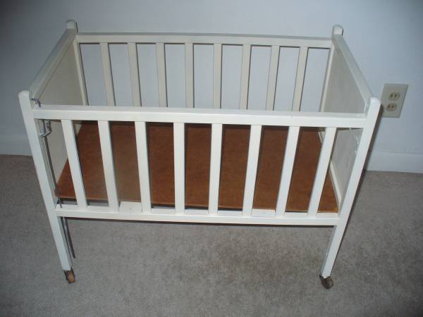 Vintage wood doll bed. On wheels 1