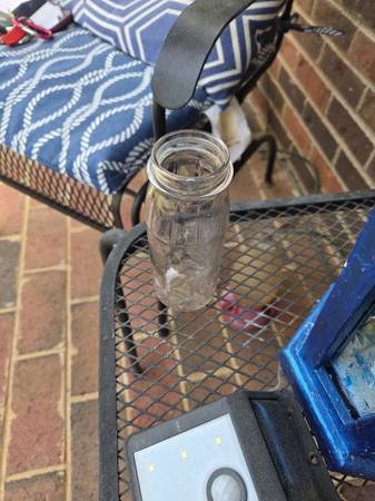Clear glass bottle has 10 ounce capacity. Item is made of thick glass with round 1