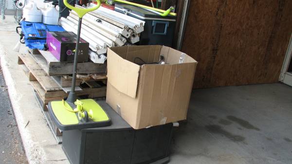 Pile of stuff, light fixtures, stadium seat, TV Stand, DEF, old cooler 1