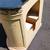 small brass sink mounted in a half moon vanity with black stone top 6 thumbnail