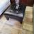 Ashley Black Faux Leather Ottoman-39"L x 29"W x 15"H-NOW 1 thumbnail