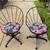 Pair of Metal Patio Swivel Chairs with Tropical Floral Cushions 1 thumbnail