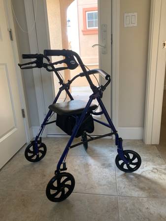 Foldable walker with padded seat in like new condition 1