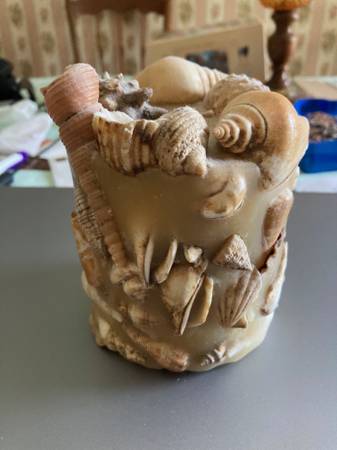 Decorative candle with embedded seashells. 1