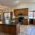 Kitchen cabinets with quarts countertops and appliances. 4 thumbnail