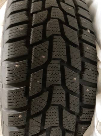 2 cooper studded snow tires on wheels 1