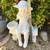 Beautiful girl with basket sitting on bench garden statue 4 thumbnail