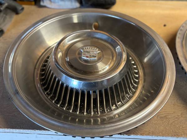 Five hub caps off a 1963 Cadillac Eldorado 1