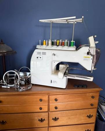 Embroidery machine with hoop system