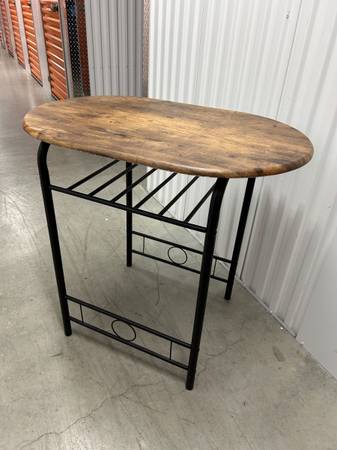 table: oval - wood-like top with black metal legs- service 4 two 1
