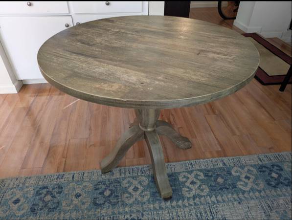 Sturdy wooden dining table with a rustic finish. 1