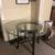 Sturdy glass top and wood base table. 1 thumbnail