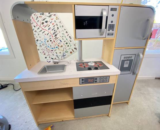 Kitchenette with fridge, oven, microwave, sink, and shelves 1