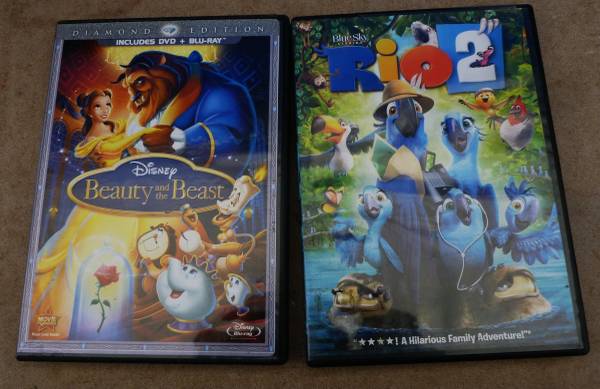 2 CDs Beauty and the Beast and Rio 2 - cds / dvds / vhs - by owner