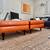 Crate and Barrel: PETRIE TUFTED LEATHER MID-CENTURY OTTOMAN /s 1 thumbnail