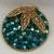 Round Teal Glass Beads With Gold Frame and Leaves Broach. 1 thumbnail