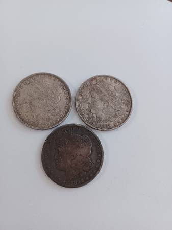 Three Morgan silver dollars 1889-O and 1892-O coins. 1