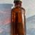 Antique Bottle Small Amber Glass Embossed 3" Tall Metal Lid 5 thumbnail