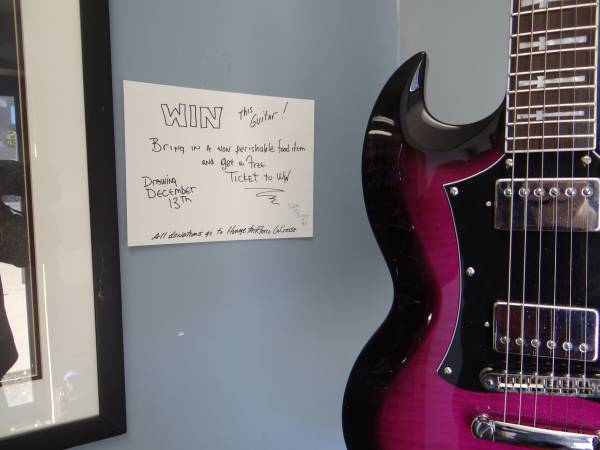Win this guitar! Bring in a non perishable and get a free ticket &win 1