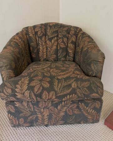 black and brown swivel accent chair featuring scalloped clamshell back and botan 1