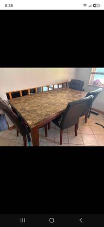 Granite table and chairs 6 chairs one has a loose leg 1