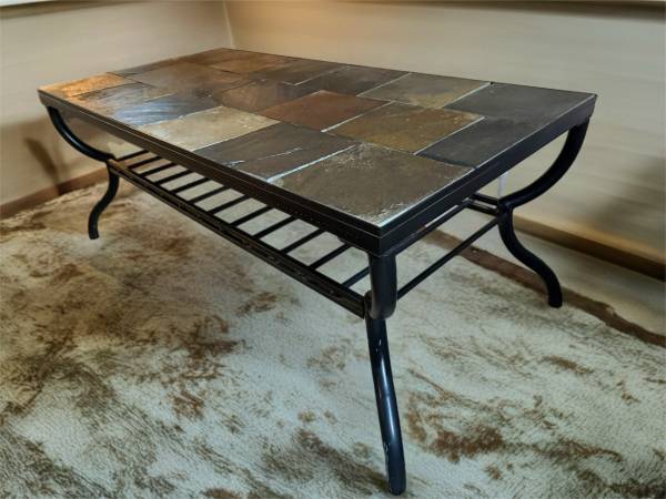 Slate tile top coffee table with black metal frame and neutral colors 1